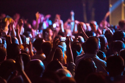 Crowd at concert and blurred stage lights  containing crowd, people, and event