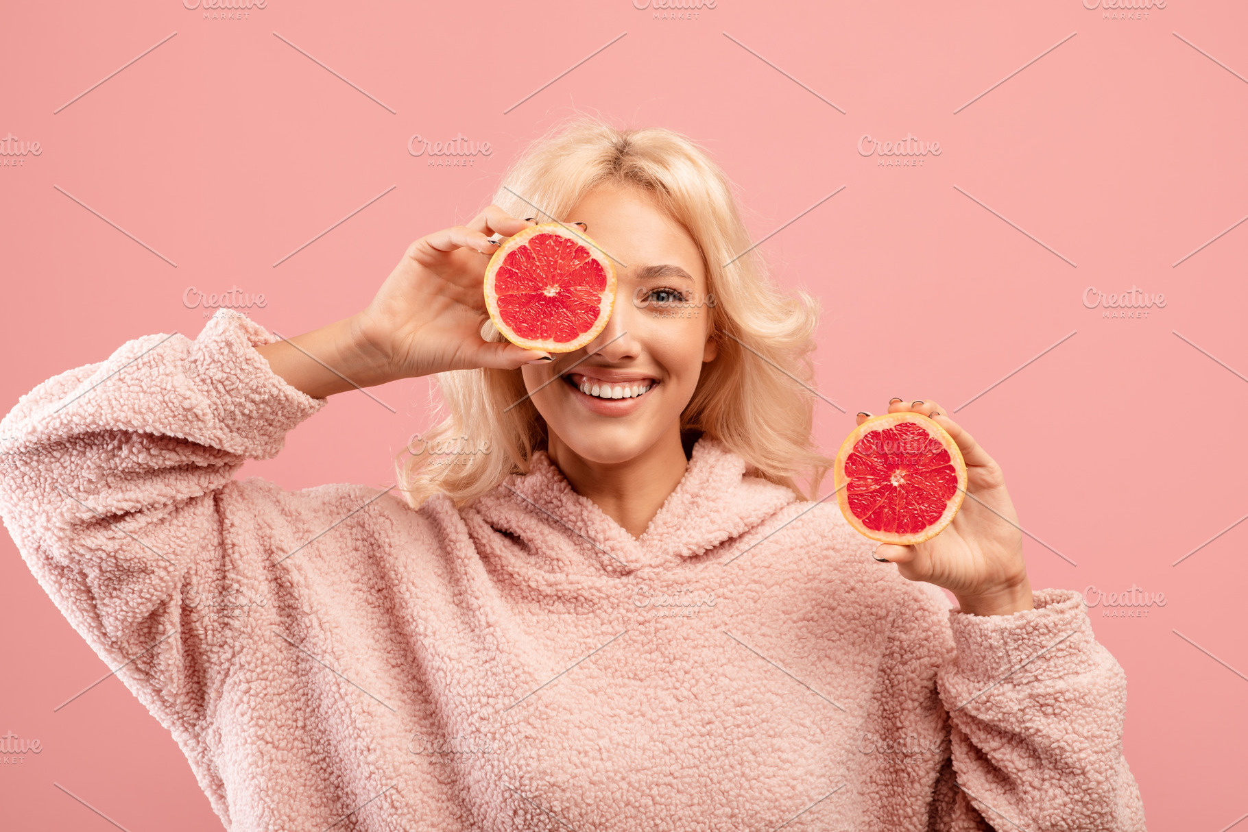 Vitamins for beauty and skin care. Happy caucasian lady posing with grapefruit, a Photo by Prostock-Studio
