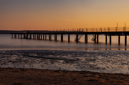 The pier at sundown. Wooded bridge seaside with Sunset, Strunjan, a Nature Photo by Bepslabor