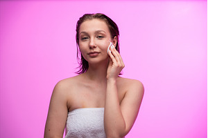 Woman gently wiping her cheek with a, a Person Photo by volodymyrshtun13795