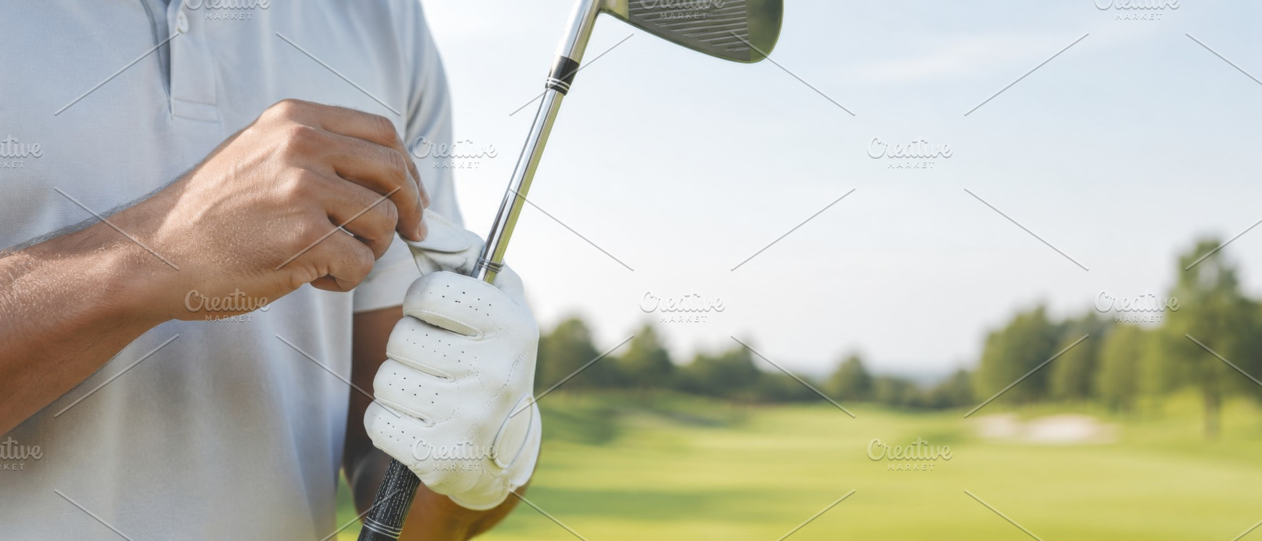 Golf player cleaning club on sunny c, a Photo by Dvoevnore photos