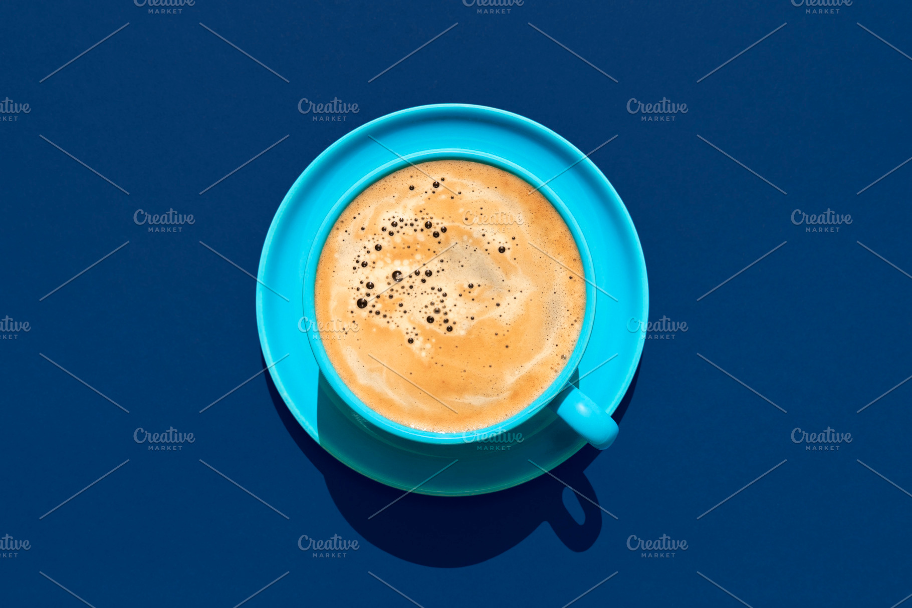 Cup of coffee above view on a blue background. Hot coffee in a b, a Food & Drink Photo by YesPhotographers