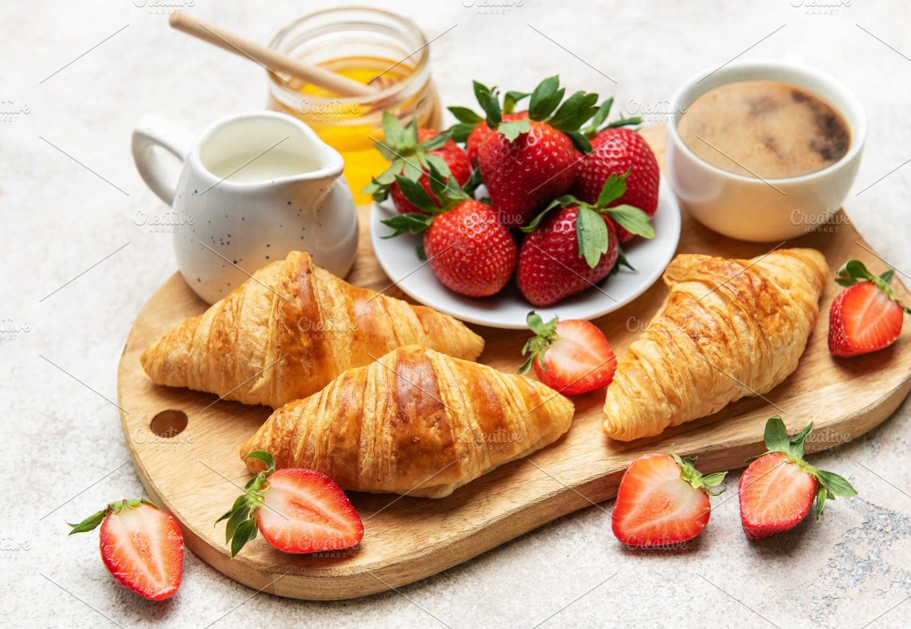 Delicious french breakfast with croissants, coffee, strawberries, a Food & Drink Photo by Olena Rudo
