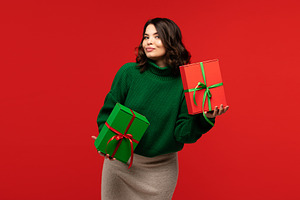 Woman in green sweater holding gift, a Holiday Photo by Elena Vagengeim