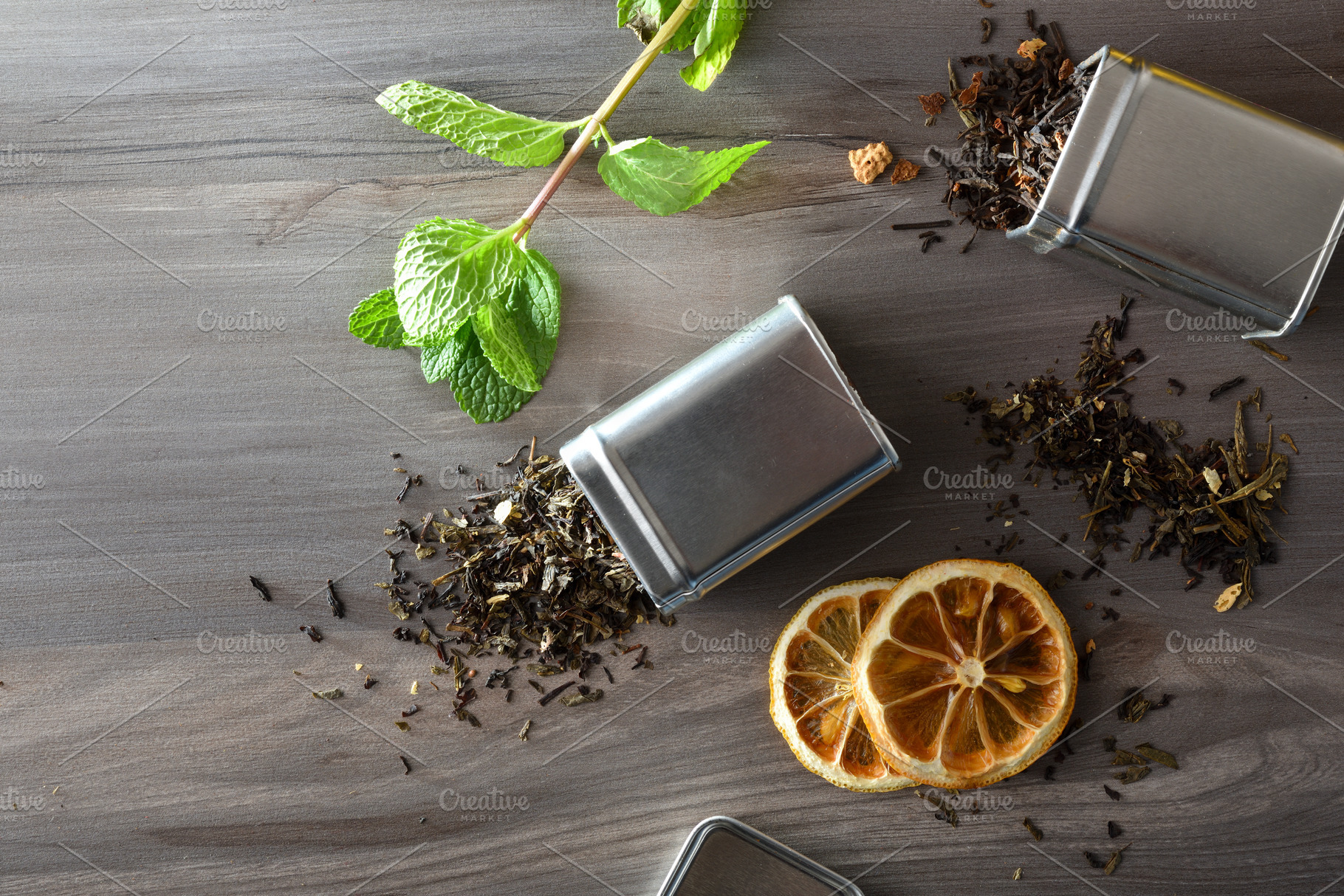 Dried black tea leaves spilling out of a metal containers, a Food & Drink Photo by Davizro's Market
