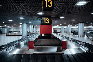 Low-key airport baggage claim hall, a Transportation Photo by SkyNext