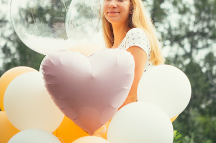 Young girl with balloons on nature b stock photo containing happy and woman