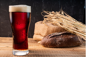 Glass of dark beer with a tall foamy, a Food & Drink Photo by Stockphoto by vzwer