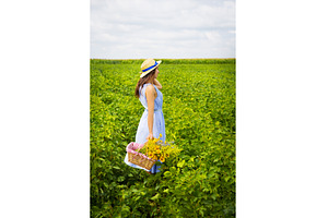Cute girl in a hat stands in a green, a Nature Photo by Artsaba Family
