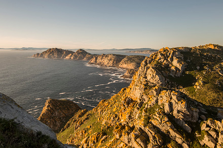 Green rocky cliff above ocean