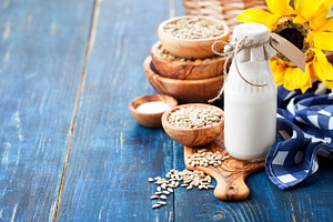 Raw vegan sunflower seed milk stock photo containing beverage and blue