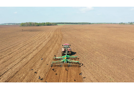 4K Aerial Flat View Tractor Plowing, an Industrial Photo by Our Amazing World
