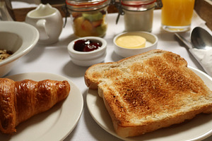 Serving a fresh continental breakfast spread with various delicacies on a white, a Photo by Studio ANNA