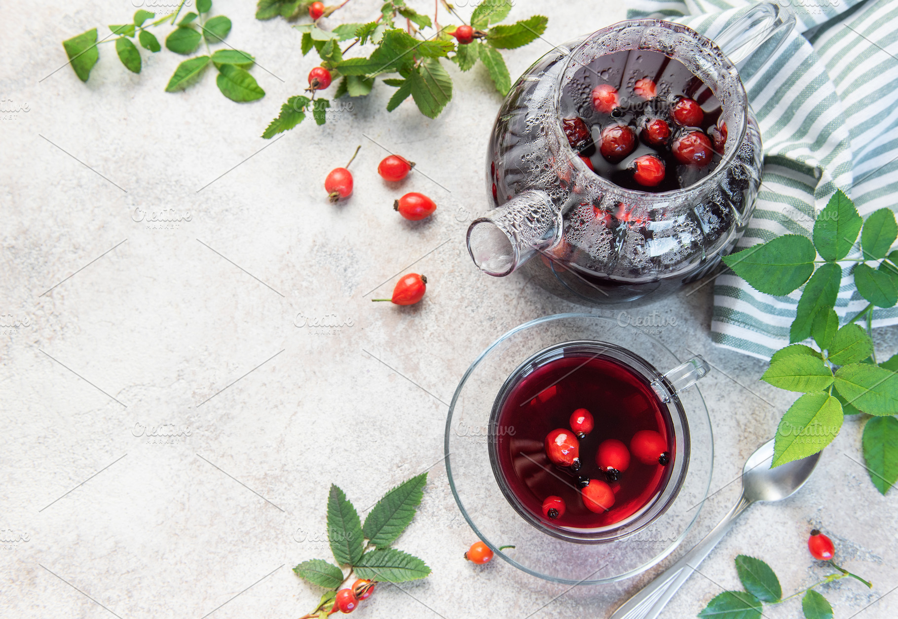 Rosehip tea brewing in glass teapot and cup with fresh rose hips, a Food & Drink Photo by Olena Rudo