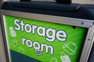 Green sign designating a storage room for bags and luggage in a facility., a Photo by AS photostudio