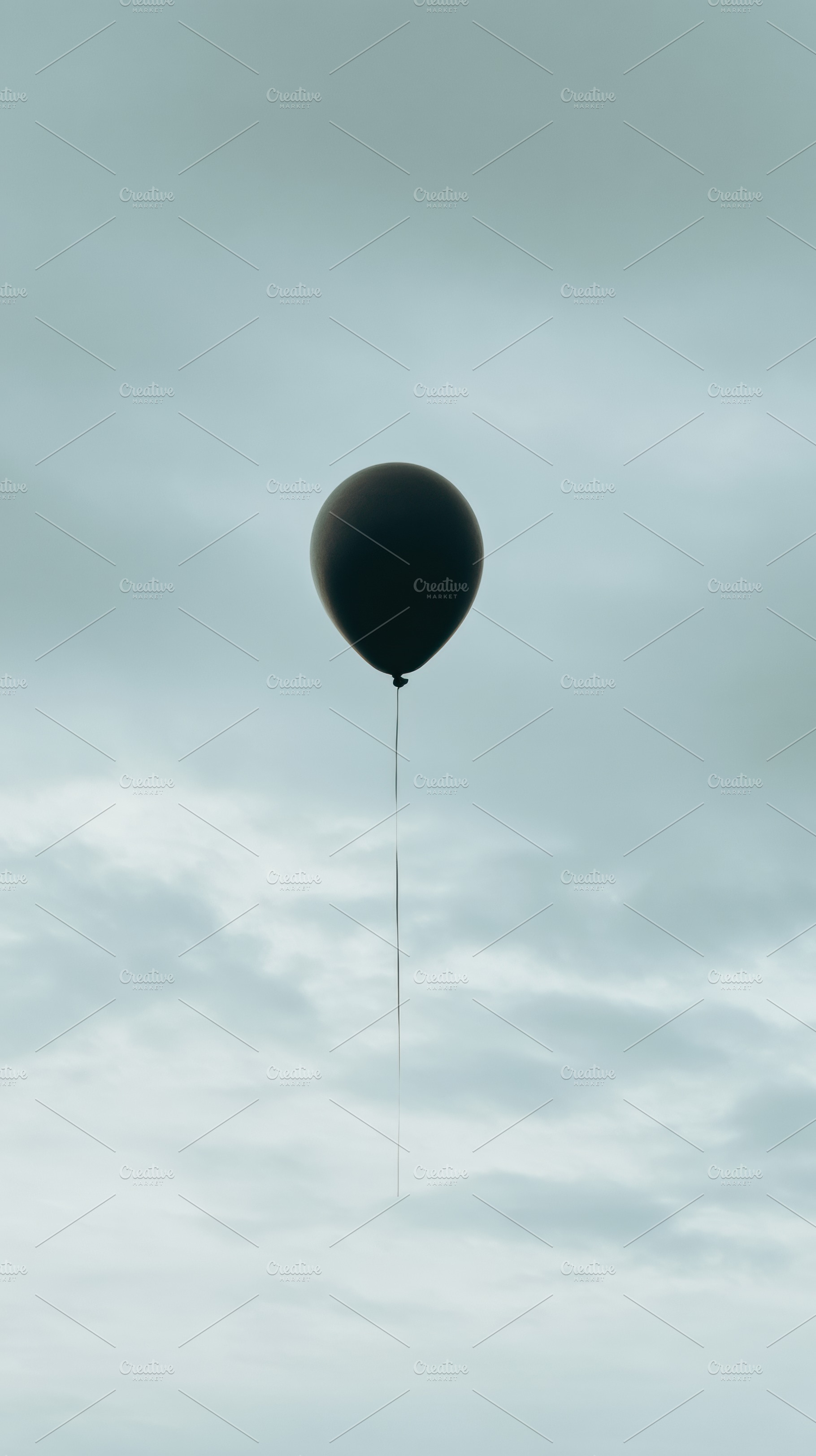 Black Balloon Against Pale Sky, a Photo by Virgo Studio