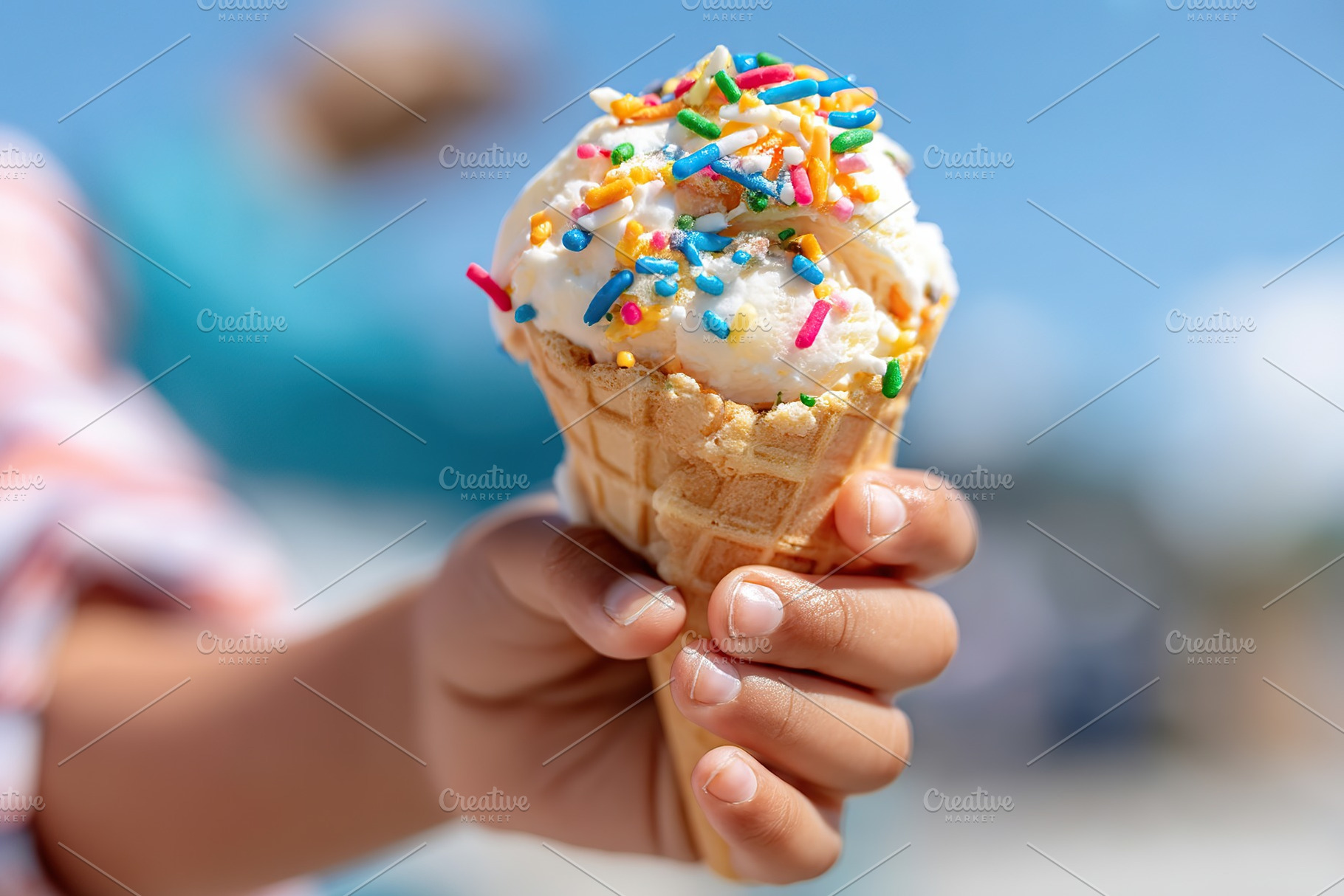 Melting ice cream cone held by child with colorful sprinkles on a sunny day, a Food & Drink Photo by AlyaAnd