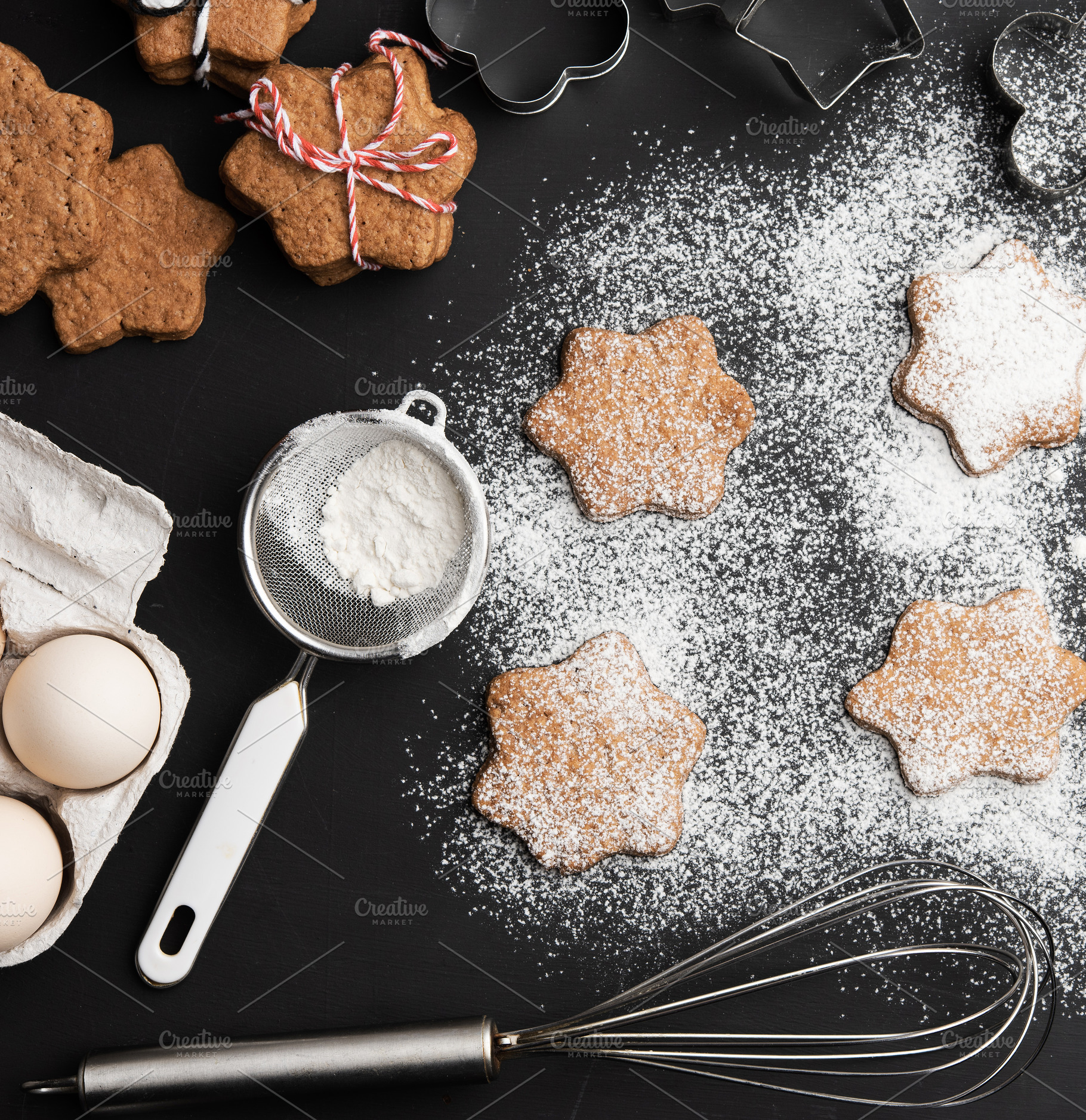 Star-shaped gingerbread cookies, sprinkled powdered sugar, metal, a Food & Drink Photo by ndanko