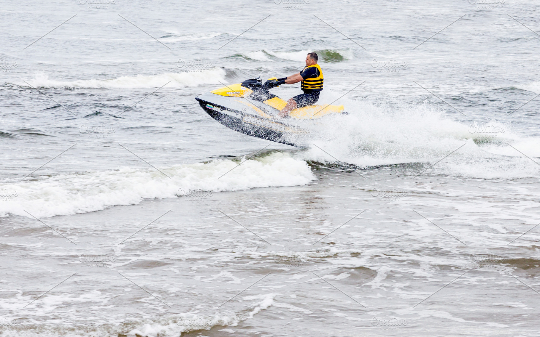Young man riding on jet ski, a Sports & Recreation Photo by BOOCYS