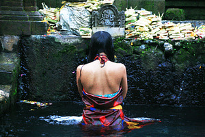 Balinese girl praying in the water stock photo containing bali and pray
