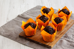 Homemade Chocolate Chip Muffins on a wooden board, side view. Co, a Food & Drink Photo by LiudmylaChuhunova