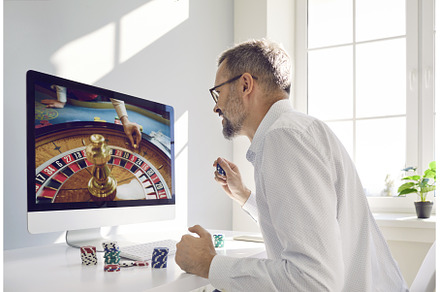 Mature man gambler places bet in, a Person Photo by StudioRomantic