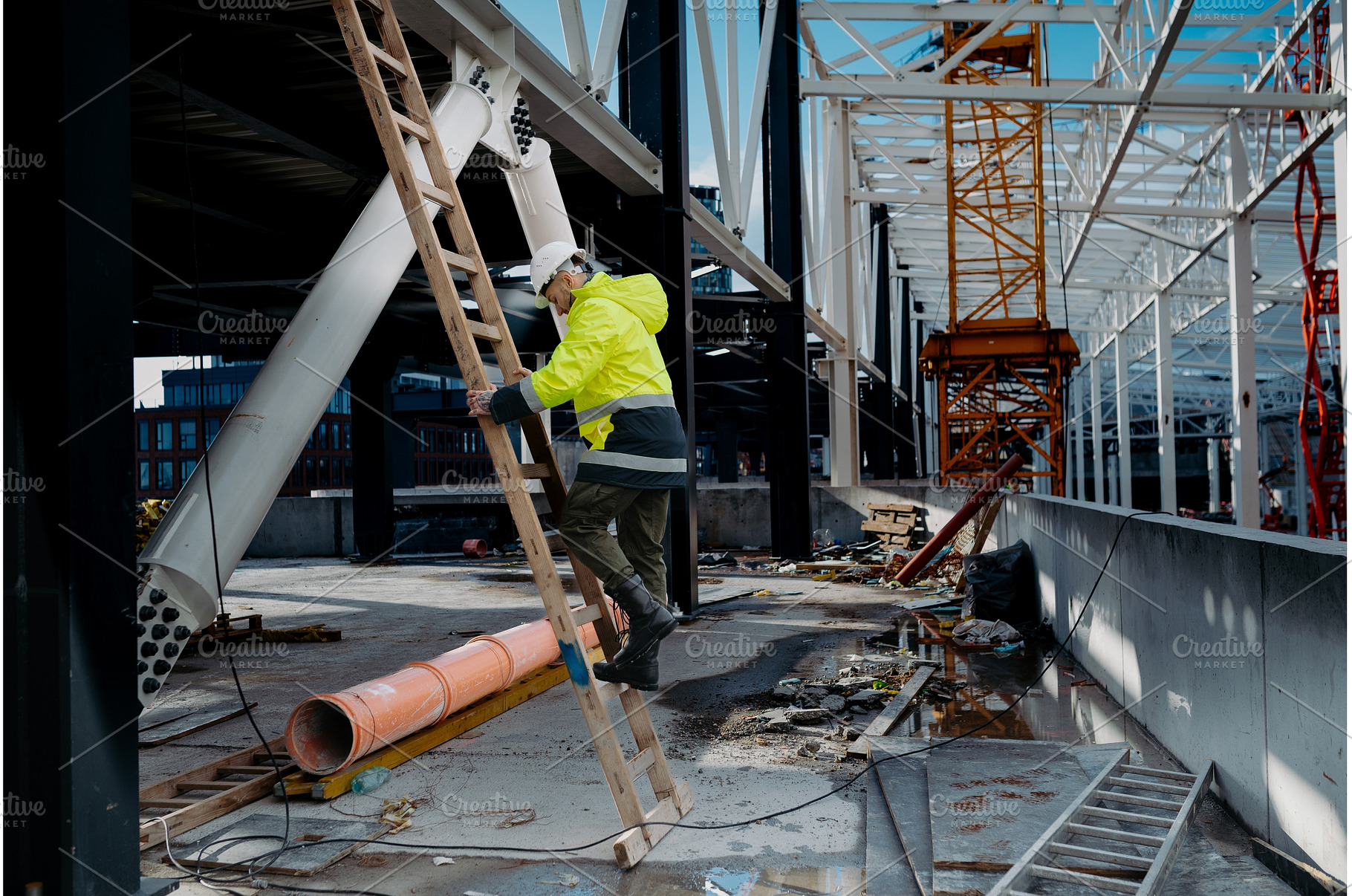 Construction worker climbing the, an Industrial Photo by HalfPoint