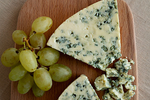 Delicious Cheese Danablu on a wooden board, top view., a Food & Drink Photo by LiudmylaChuhunova