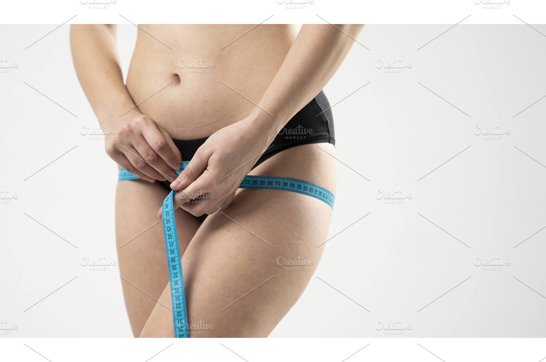 Woman measuring thigh with tape, a Sports & Recreation Photo by volodymyrshtun13795