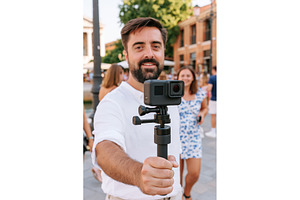 Man vlogging, records video walking, a Person Photo by Lermont51