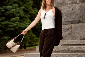 Young woman posing elegantly on ston, a Person Photo by Elena Vagengeim