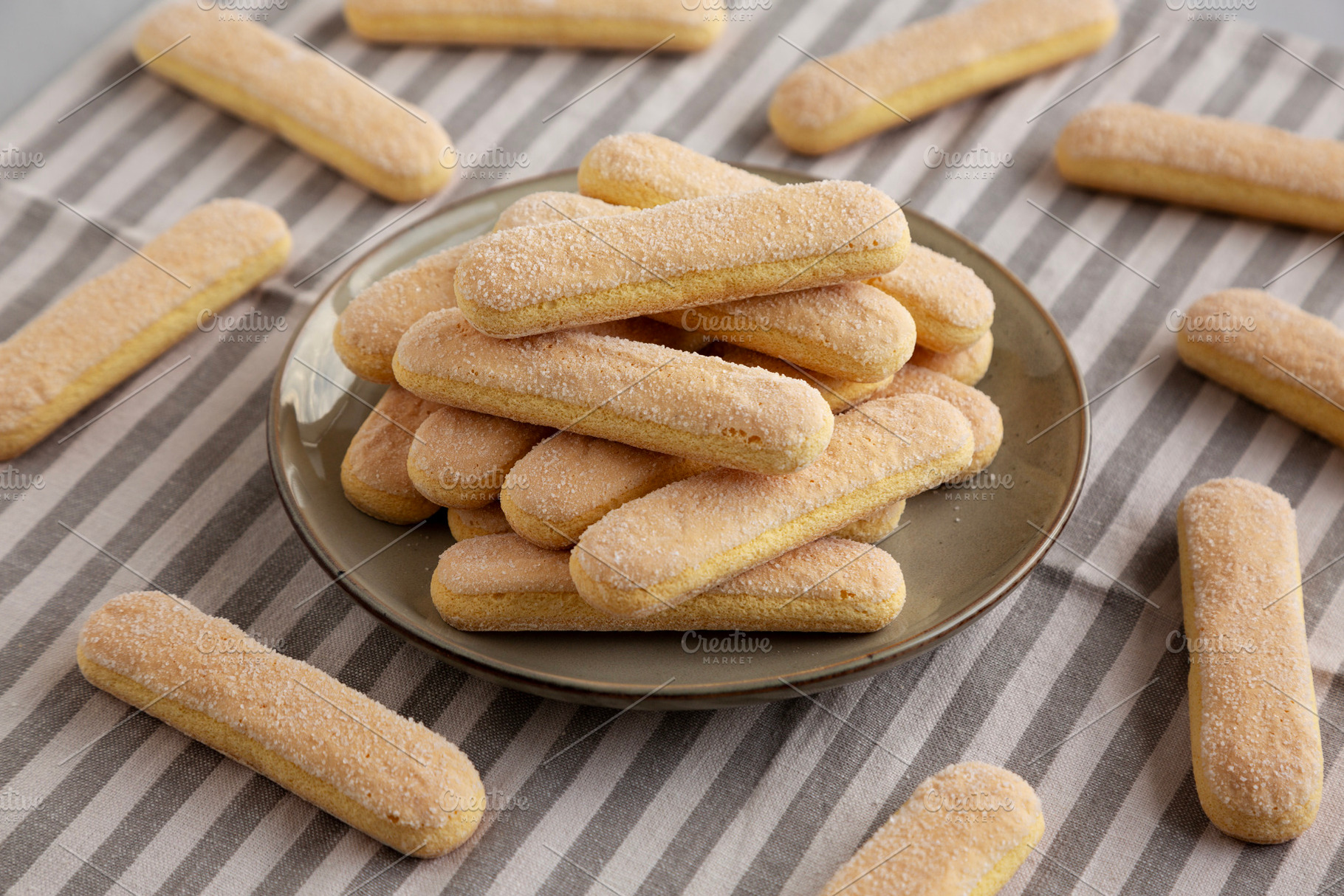 Savoiardi biscuits on a plate, side view., a Food & Drink Photo by LiudmylaChuhunova