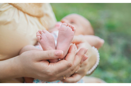 Feet of a newborn baby in mom's, a Person Photo by yanadjana
