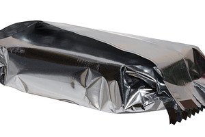 Crumpled silver foil packaging with torn edges, isolated backgro, an Industrial Photo by ndanko