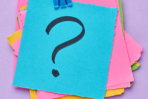 A stack of multi-colored square sticky notes with a question mar, a Business Photo by ndanko