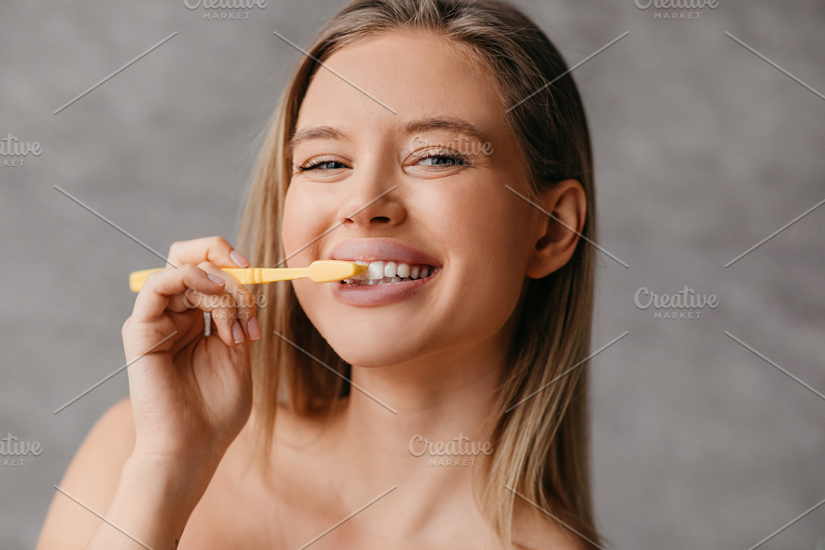 Healthy teeth and care. Happy lady brushing teeth with toothbrush and smiling a, a Photo by Prostock-Studio (Photo 4 of 5)
