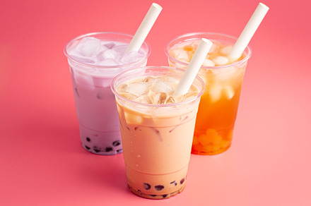 Three Different Types of Boba Tea on a Bright Pink Background