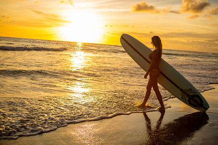 Surfing all day long featuring beach, sunset, and surf