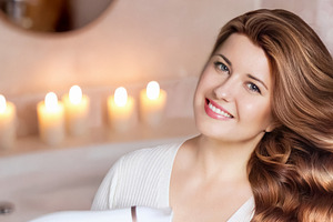 Woman smiling while drying long wavy hair in a cozy bathroom, en, a Person Photo by Studio ANNA