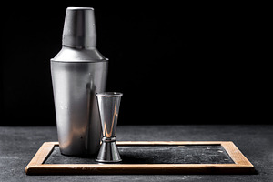 Cocktail shaker and jigger on dark bar background with copy space, a Food & Drink Photo by etorres69