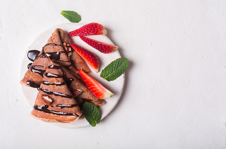 Traditional french crepes cooked wit containing chocolate, crepe, and wooden, a Food & Drink Photo by zakiroff
