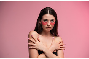 Woman posing with hydrating pink eye, a Health & Medical Photo by volodymyrshtun13795