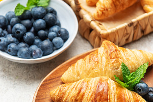 Delicious french croissants with fresh blueberries and honey for, a Food & Drink Photo by Olena Rudo