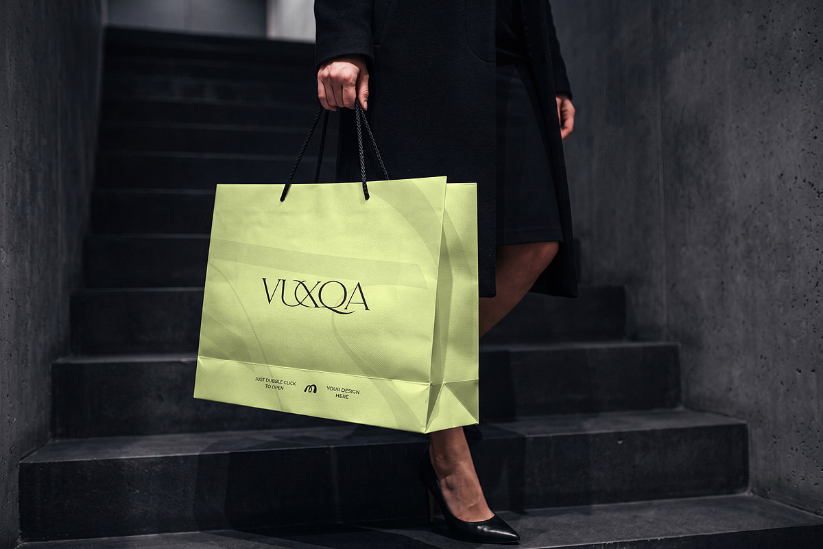 Paper Shopping Bag Mockup with Model, a Packaging Mockup by graphypix (Photo 1 of 4)