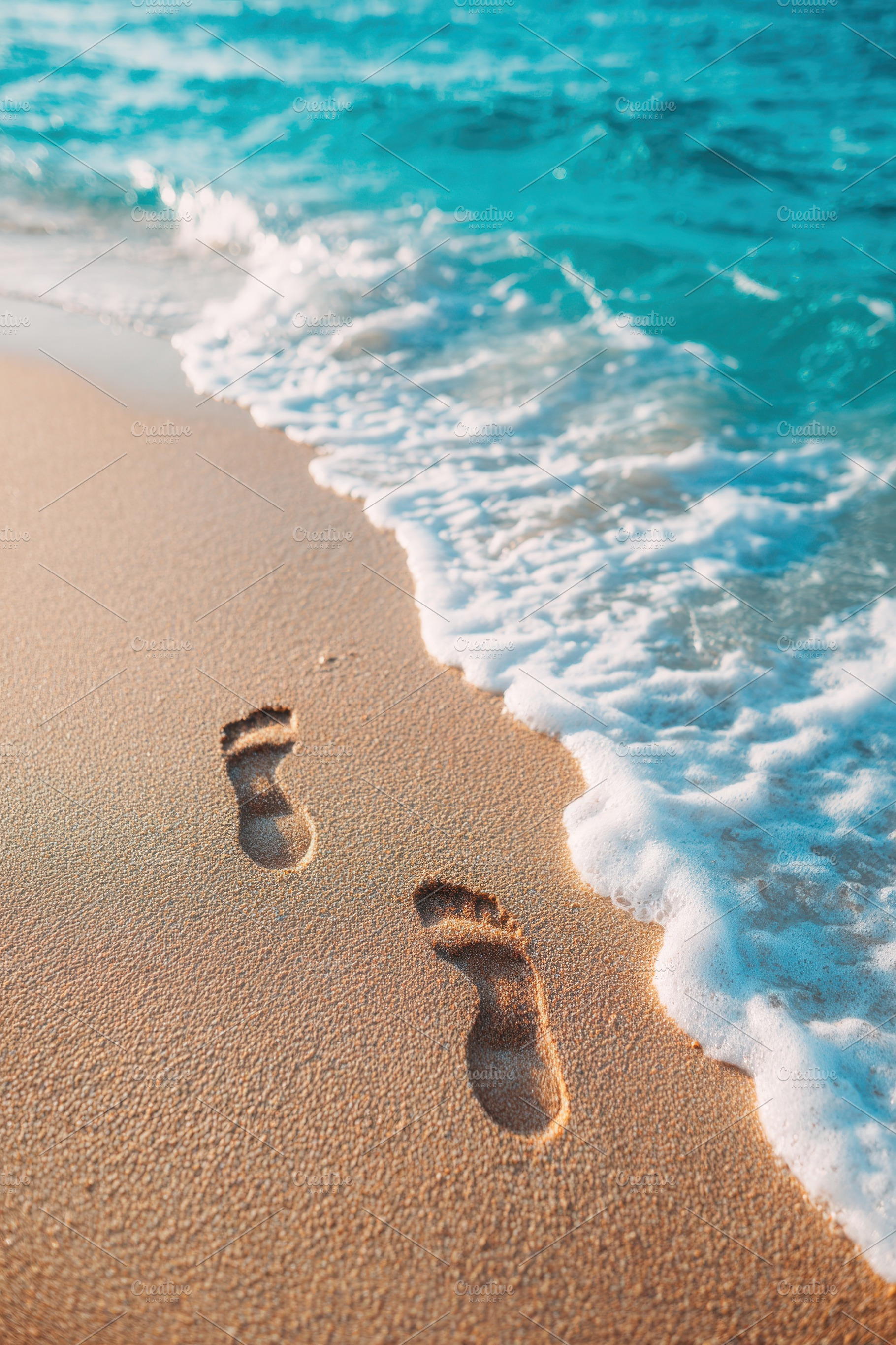 Footprints on a sandy beach by the ocean, a Nature Photo by AlyaAnd