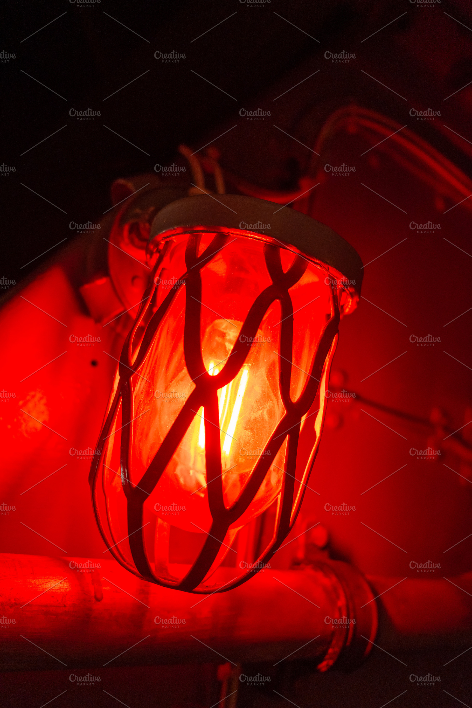Red alarm light inside an old military submarine with protective, an Architecture Photo by GoodGoods