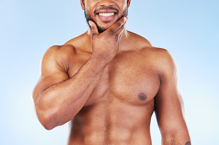 Smile, shower towel and portrait of a black man with fitness happiness from bodybuilder muscle. Cleaning, skincare and wellness after workout and exercise with isolated, studio and blue background, a Photo by Peopleimages.com