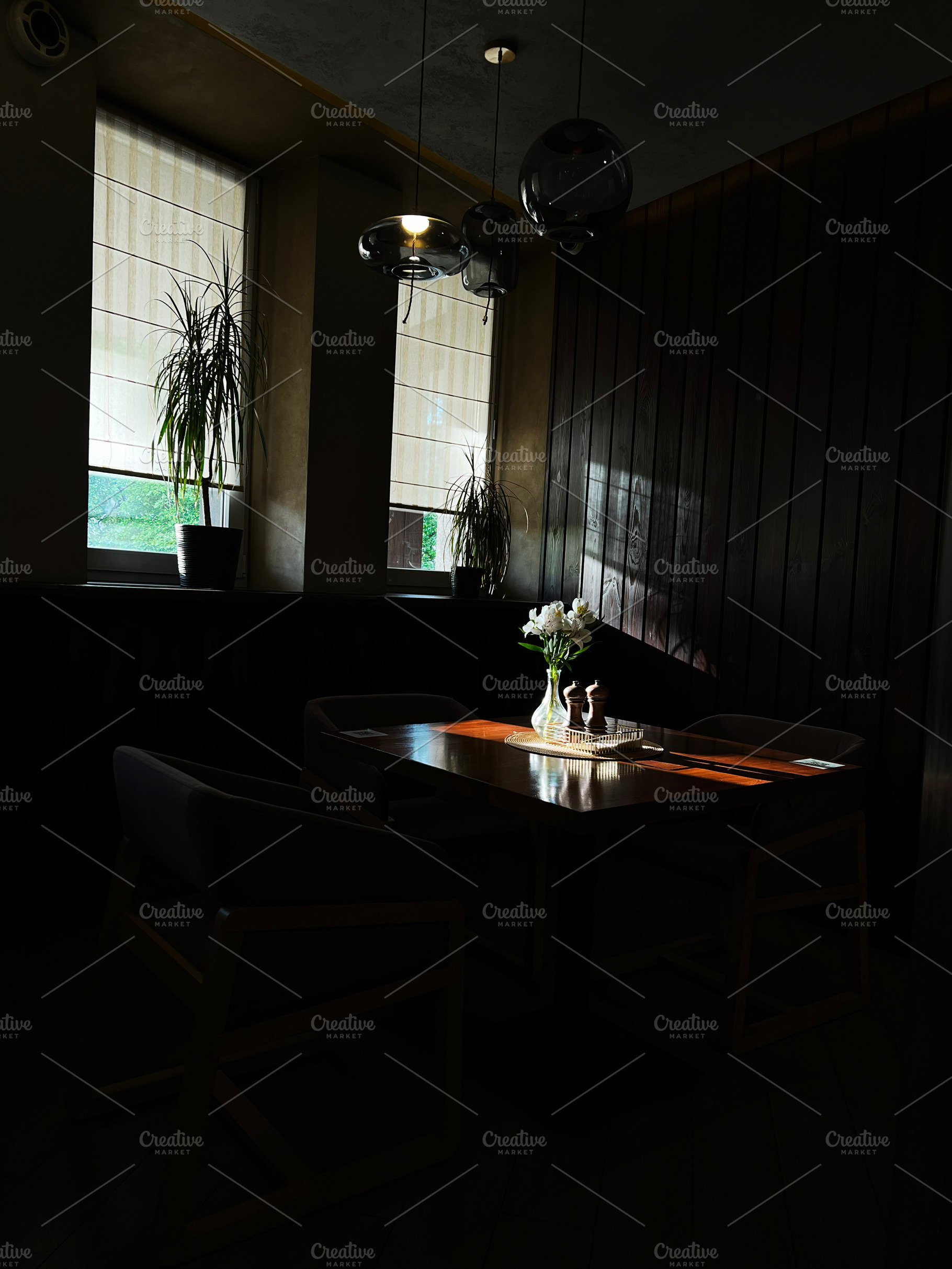 Cozy dining table beside large windows in a warmly lit room, a Photo by AS photostudio