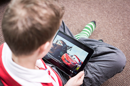 Watching cartoon on iPad, an Arts & Entertainment Photo by Twin Design