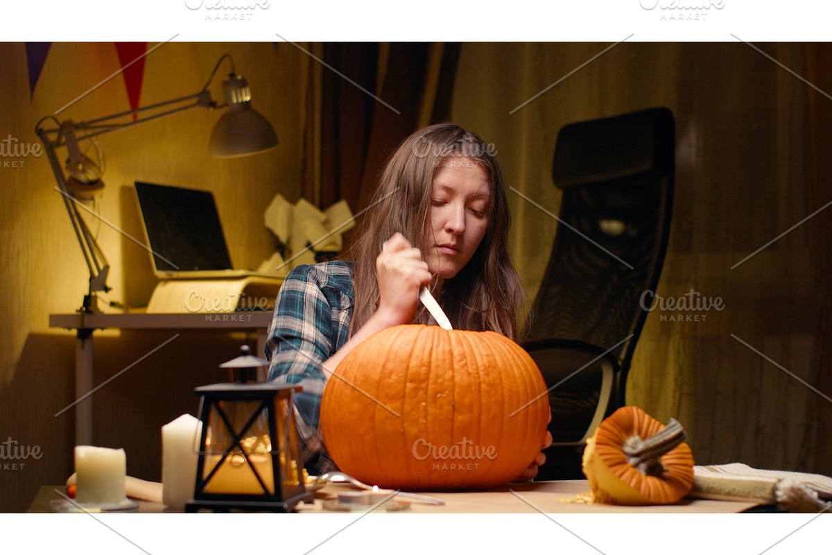 Woman carving Jack O Lantern pumpkin, a Graphic by sergeypeterman